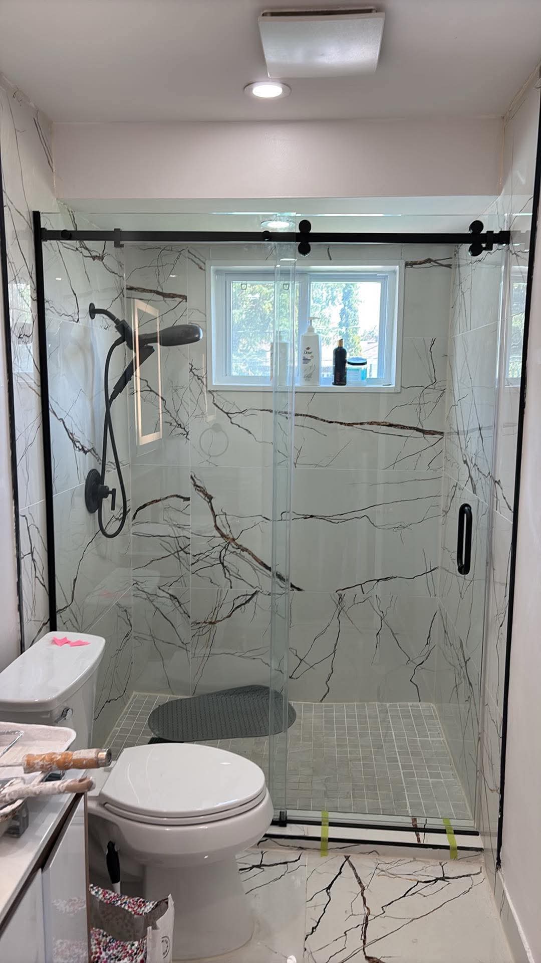 Douche coulissante noire réalisée par Vitrerie Synette